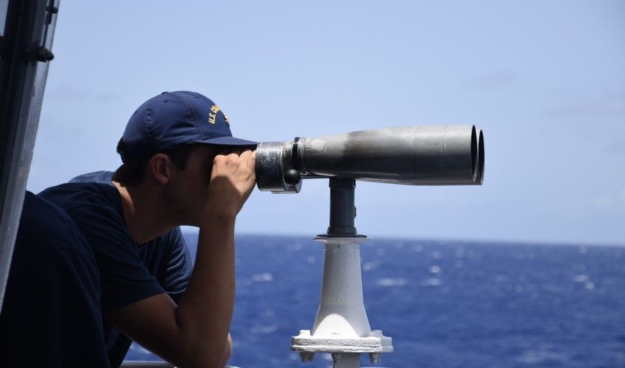 A Coast Guard Cutter Thetis (WMEC 910) crew member serves as a lookout, June 29, 2024, during a safety and security patrol in the Windward Passage and Florida Straits. -- Image: U.S. Coast Guard photo by Ensign Kevin Wong