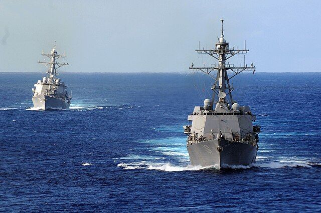 The guided-missile destroyer USS Gridley (DDG 101), right, and the guided-missile destroyer USS Howard (DDG 83)