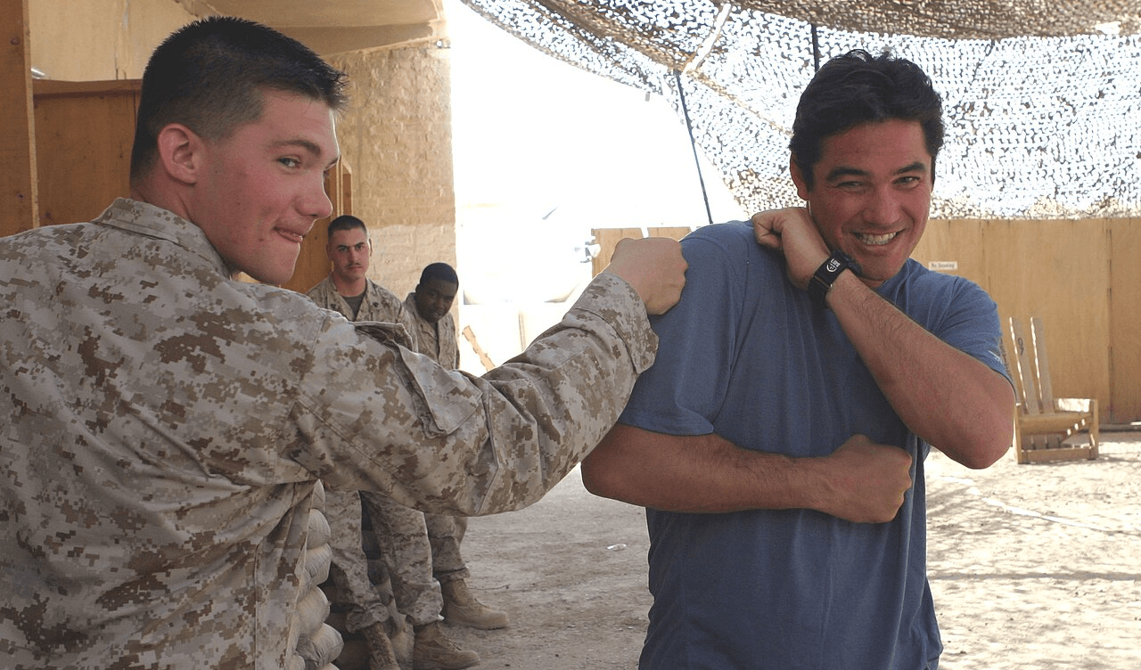 Dean Cain jokes around with service members at Camp Taqaddum May 14, 2005 as part of the Ambassadors of Hollywood tour.