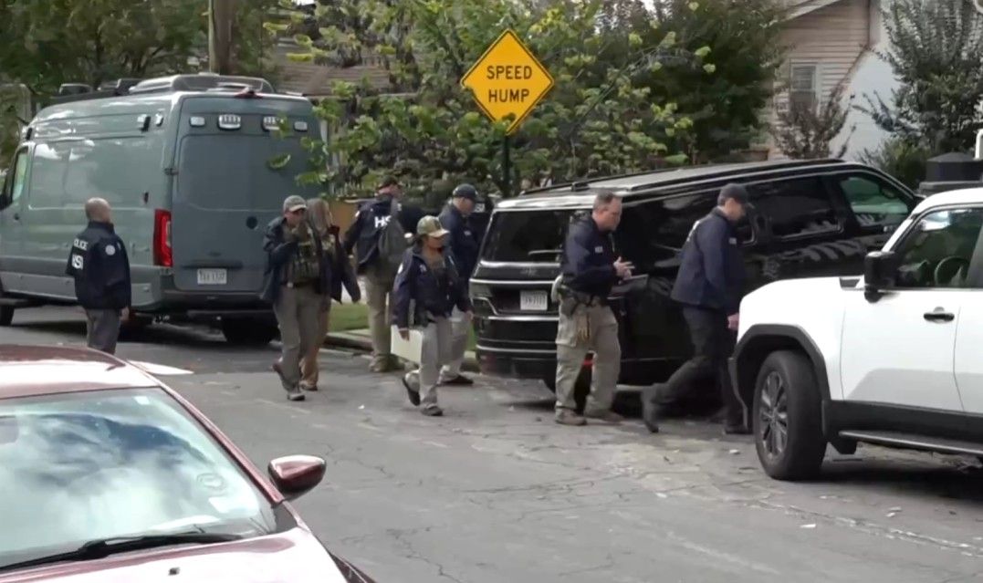 Federal Agents prepare to leave Ilhan Omar's Washington area home after removing boxes.