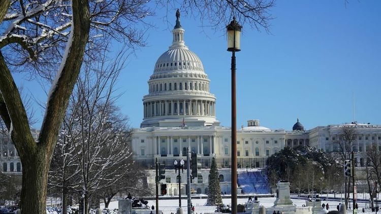 Winter scene of the Capitol Building covered in snow