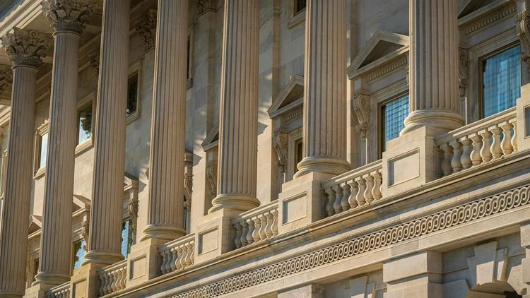 A detailed view of the Corinthian columns and architectural features of the U.S. Capitol