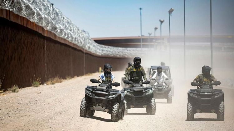 Homeland Security Secretary Kristi Noem rides an ATV along the U.S.-Mexico border wall in El Paso, Texas