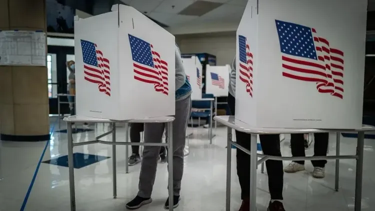 Voters cast ballots behind privacy flaps on Election Day. 