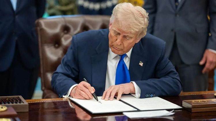 President Donald Trump signs executive orders in the Oval Office, May 5, 2025.