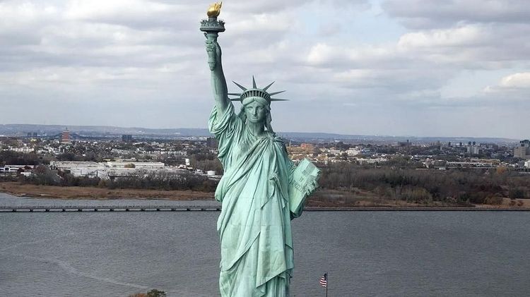 The Statue of Liberty stands on Liberty Island in New York Harbor