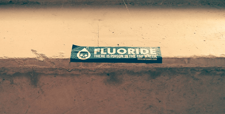 An anti-fluoride sticker is seen on an overpass
