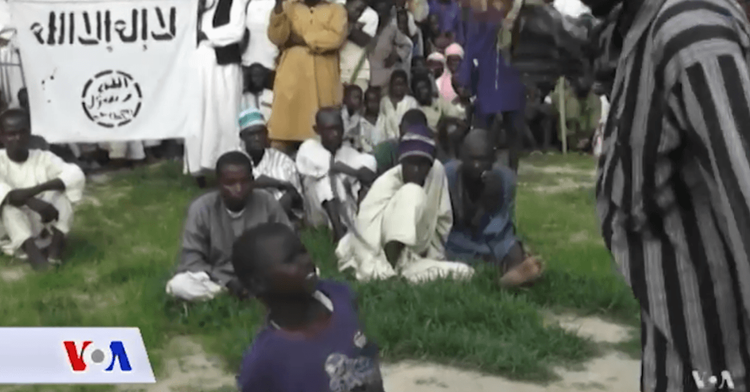 A Boko Haram member is seen whipping a child
