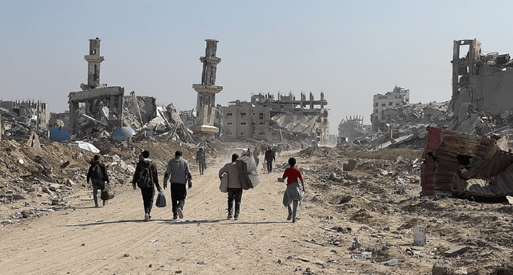 Refugees walking through a destroyed city
