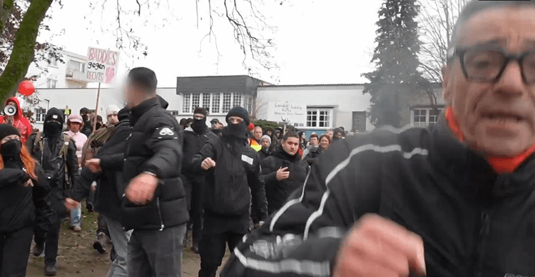 A German Antifa member punches a cameraman. Screenshot from the cameraman's point of view.