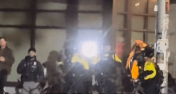 Video posted by @nicksortor on X showed Portland police shielding Antifa protestors that were shining high intensity lights at the eyes of Federal Agents.