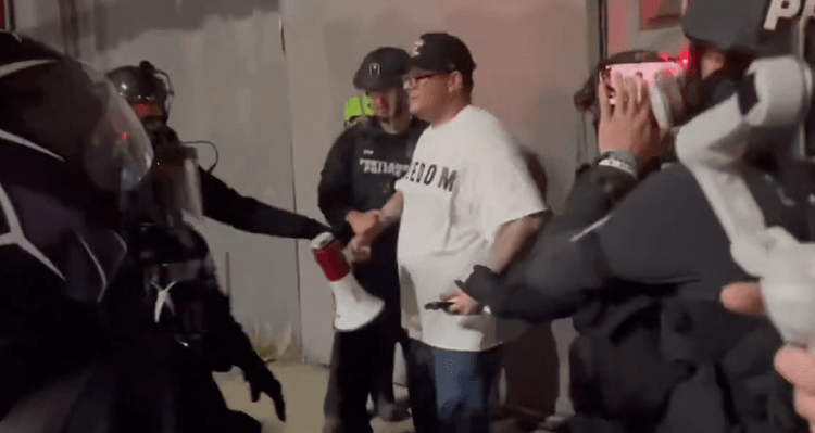 Portland Police arresting a man in a white "freedom" t-shirt