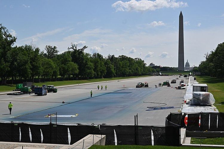 A view of the Reflecting Pool resurfacing, looking towards the WWII memorial with the Washington Monument and the Capital dome in the background. National Mall, Washington, DC April 30, 2026