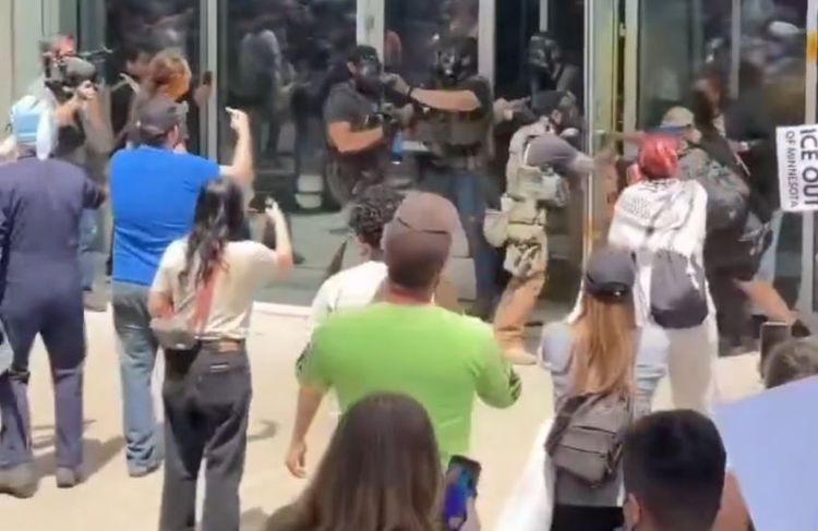Rioters attempting to breach the St. Paul Courthouse are pushed back.