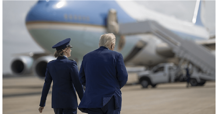 President Trump walks toward Air Force One with an unidentified military Officer.