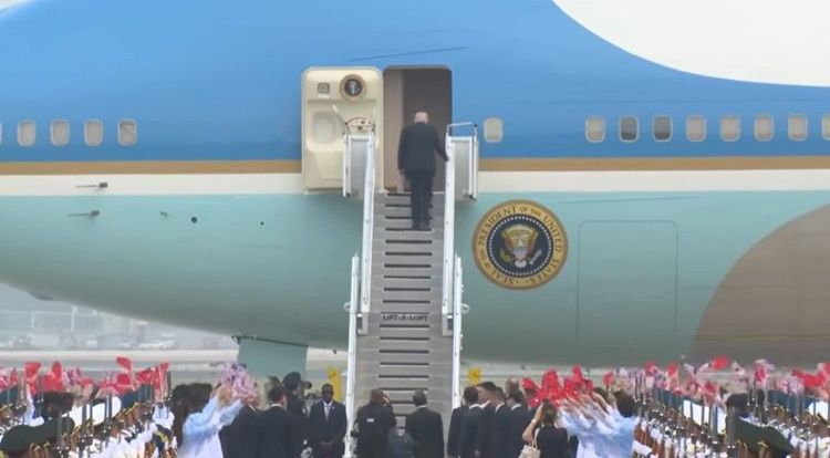 President Trump boards Air Force One as he prepares to depart China.
