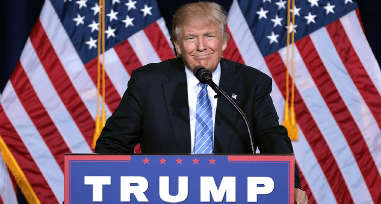 President Trump at a campaign podium grinning