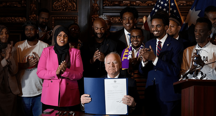 Governor Walz at the Uber-Lyft Bill signing backed by Somalis and others.