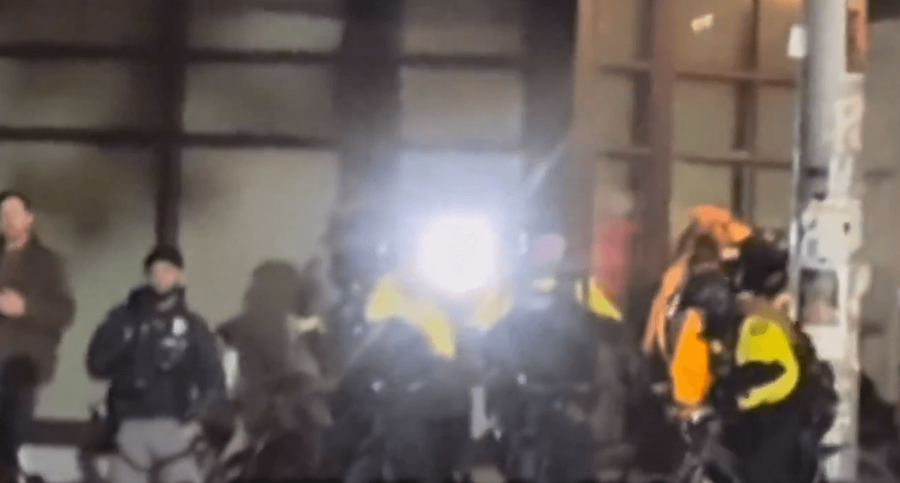 Video posted by @nicksortor on X showed Portland police shielding Antifa protestors that were shining high intensity lights at the eyes of Federal Agents.