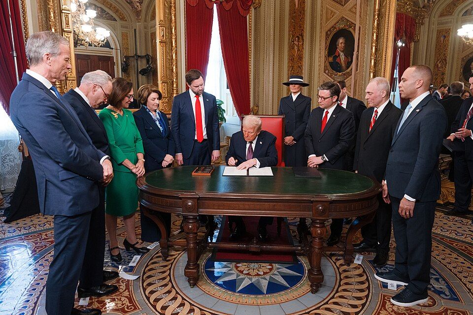 President Trump signs documents surrounded by members of Congress, inauguration Day 2025